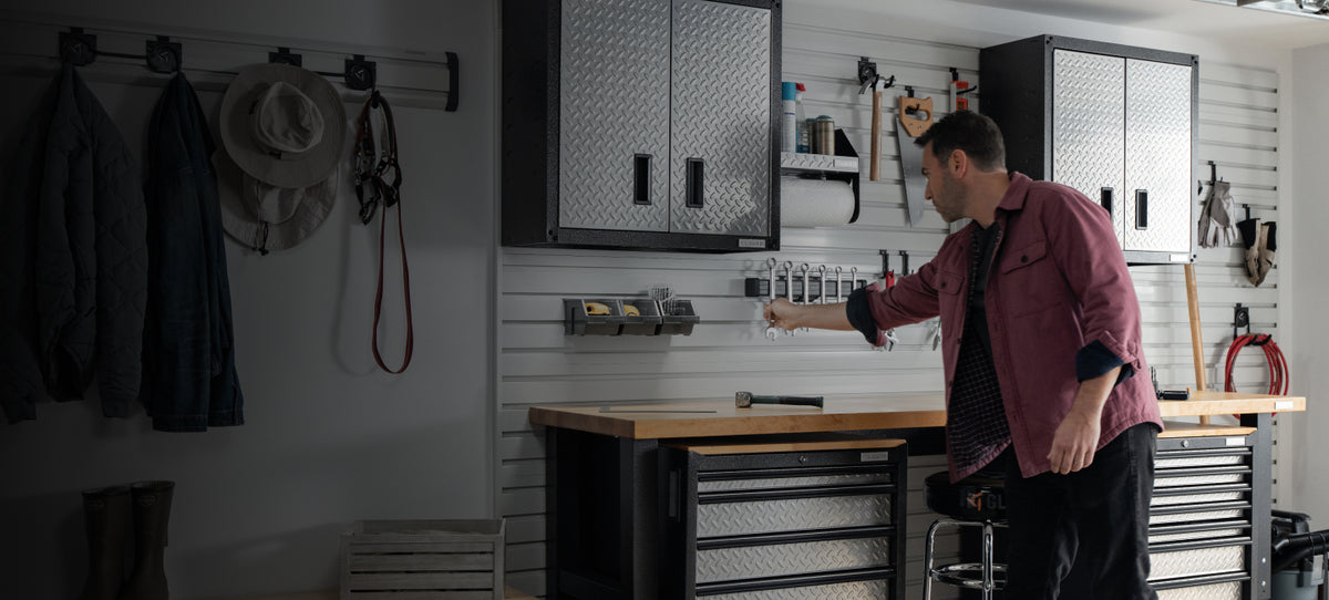 A man grabbing a tool off of his Gladiator® products