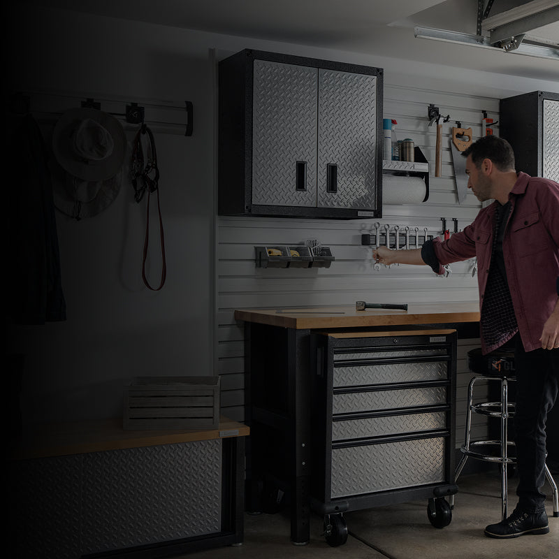 A man grabbing a tool off of his Gladiator® products
