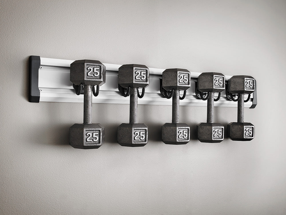  series of dumbbells hung on a Gladiator brand wall storage unit.