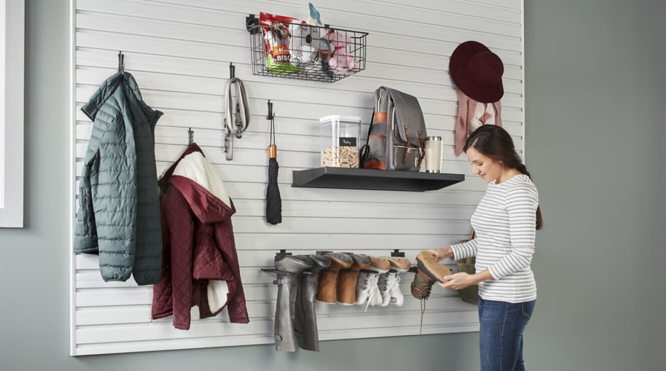 A person hanging a shoe on a Gladiator® GearWall® Panel