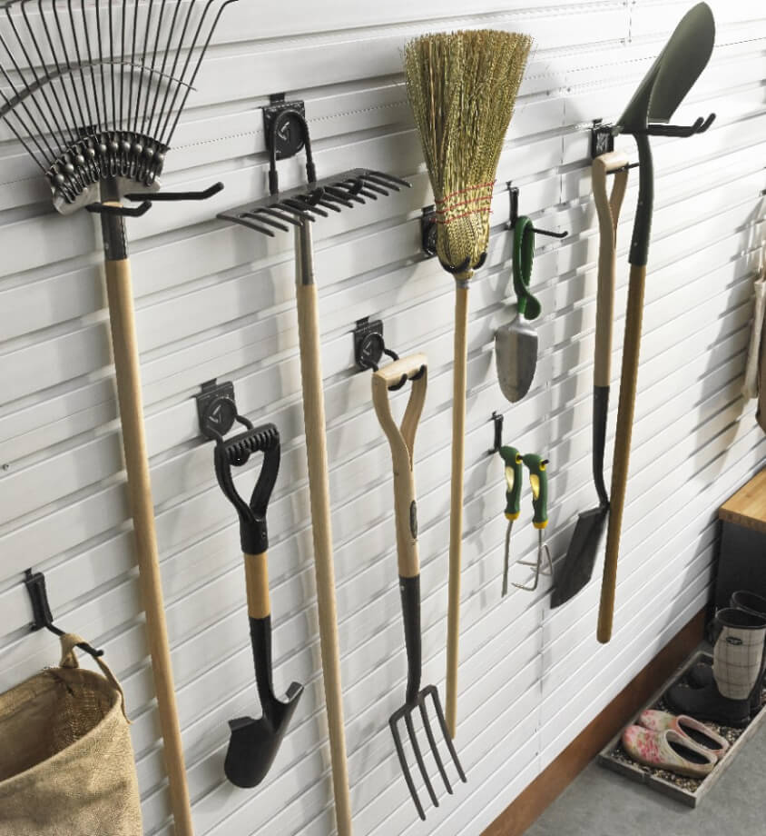 Various lawn equipment hanging on a Gladiator® GearWall® Panel