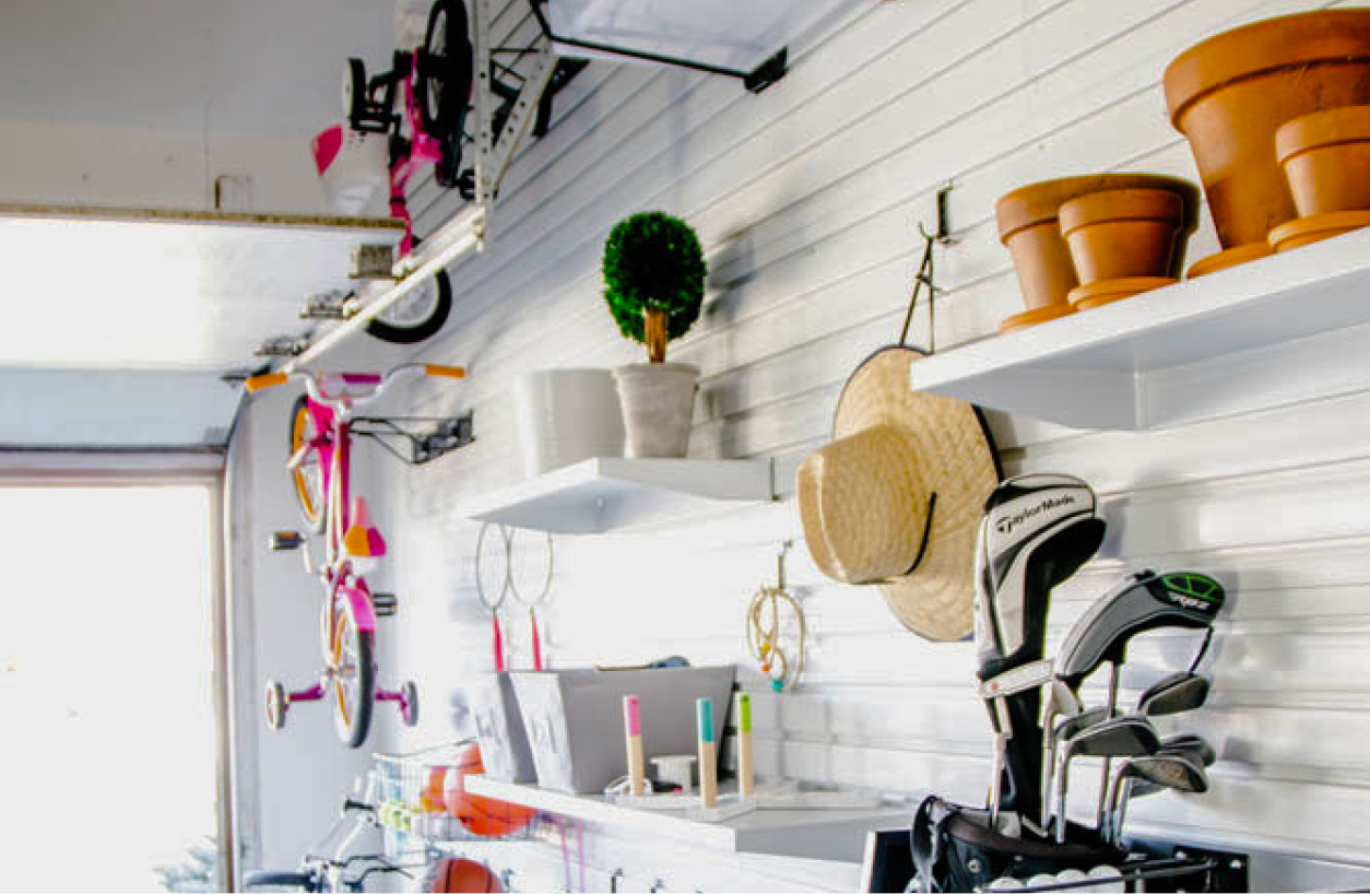 Gardening supplies, bikes and sports equipment hung on a Gladiator® GearWall® Panel.