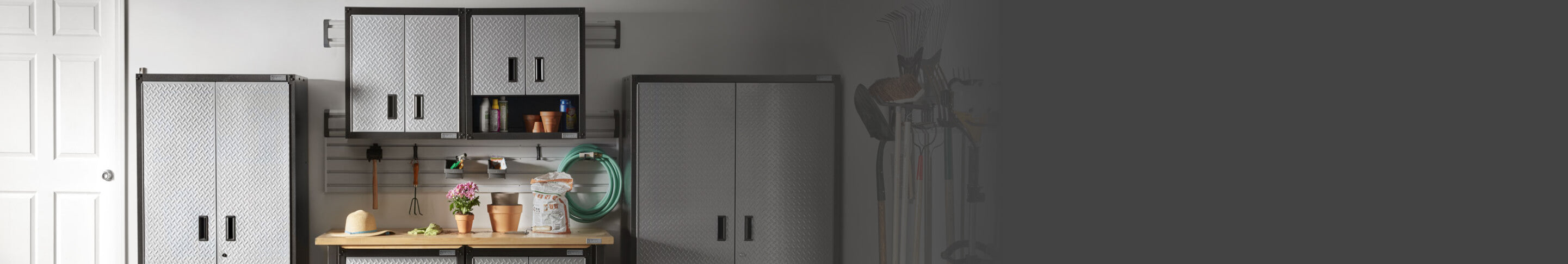 Four Gladiator brand garage cabinets arranged in a garage.