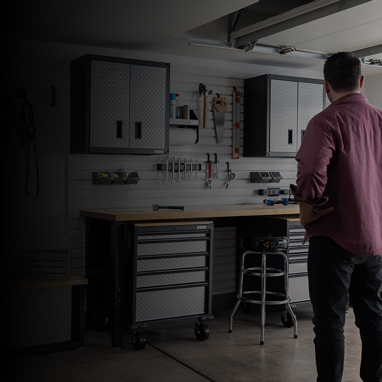 A dad looking at his organized Gladiator® storage solutions