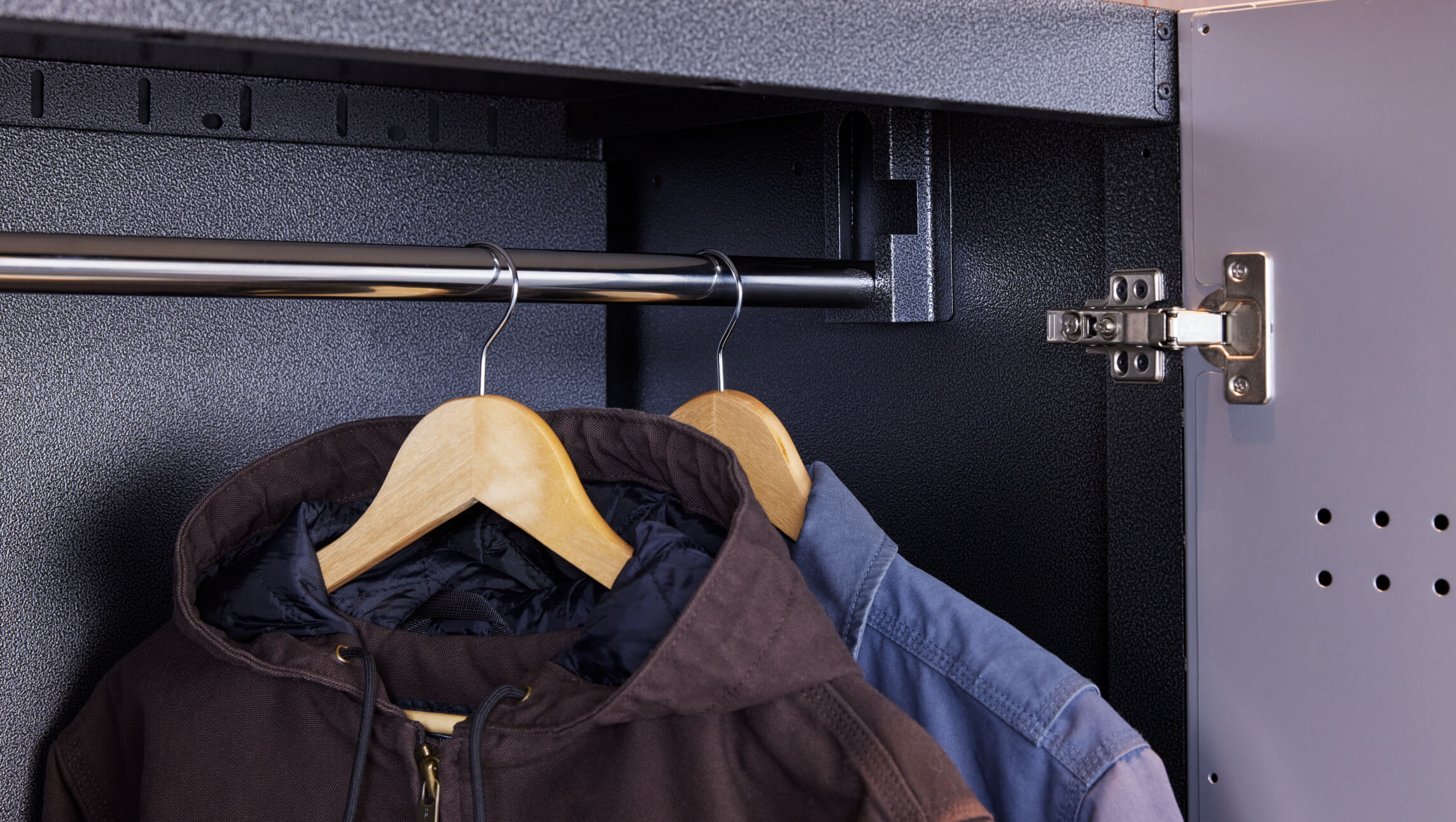 A closeup of clothes hanging on a clothing rack.