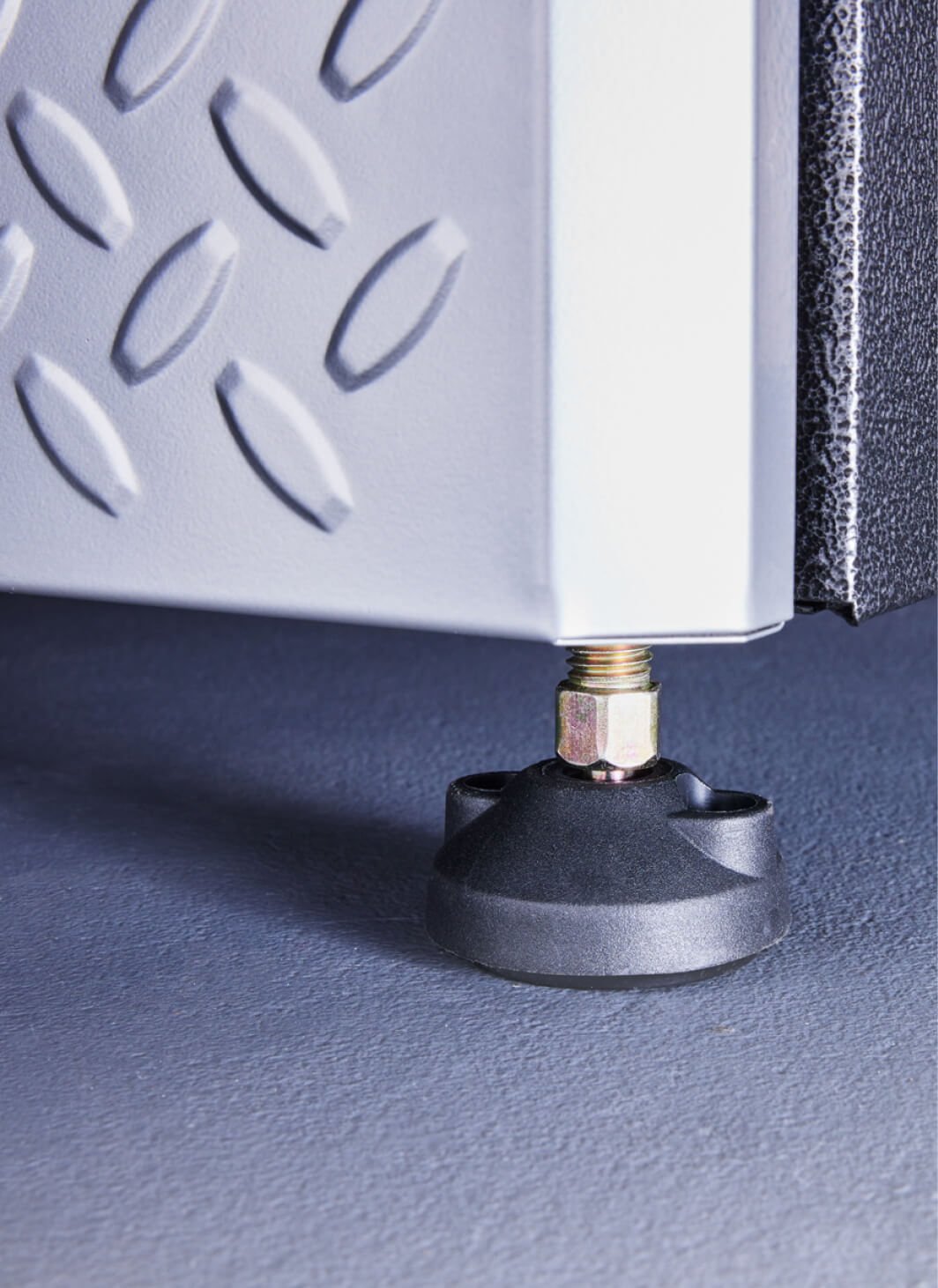 A closeup of a self-leveling foot on a Gladiator® cabinet.