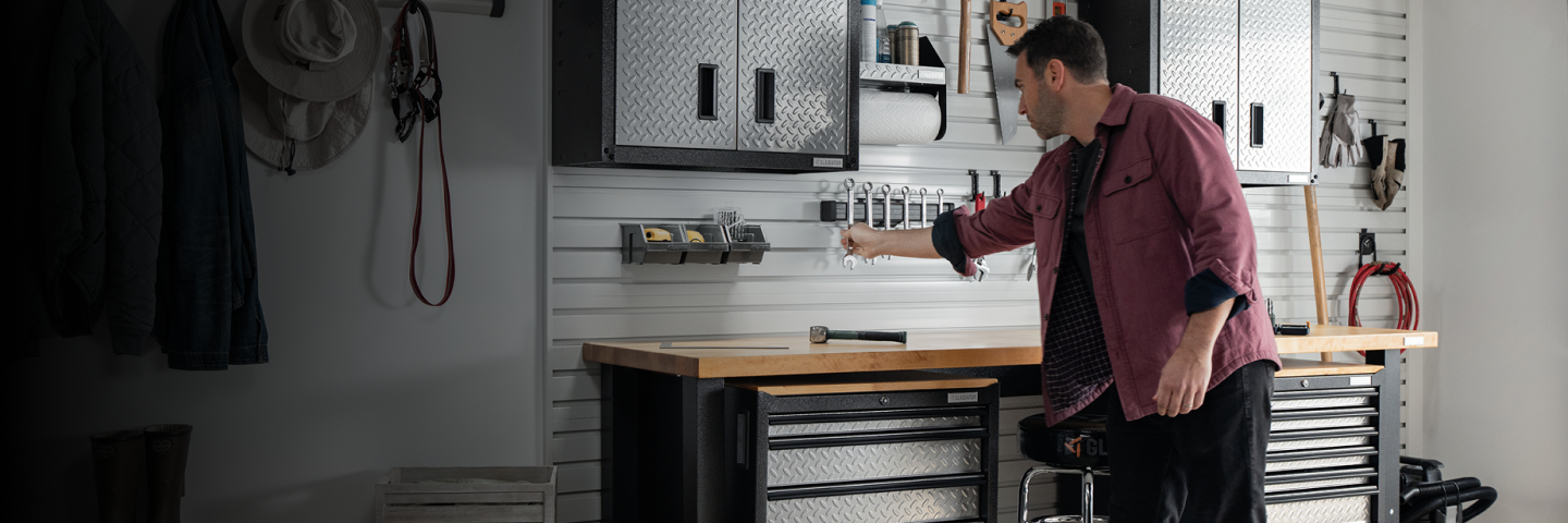 A man grabbing a tool off his Gladiator® GearWall