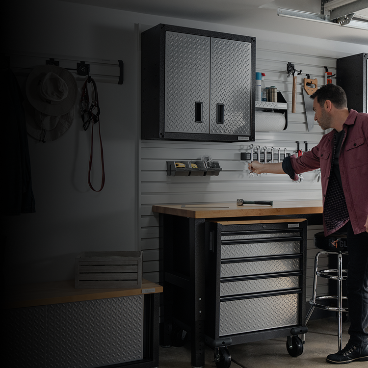 A man grabbing a tool off his Gladiator® GearWall