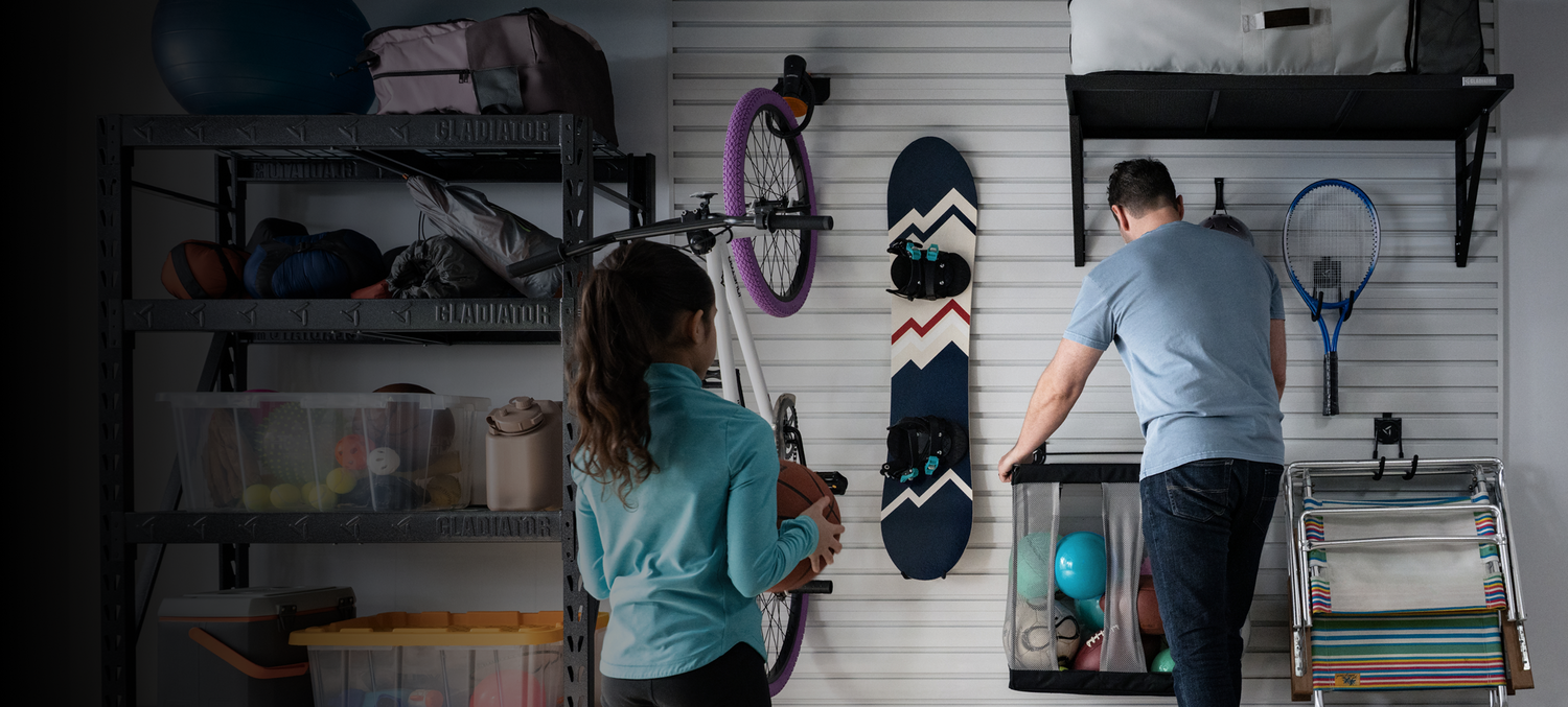 Two people organizing their garage using Gladiator® GearWall®.